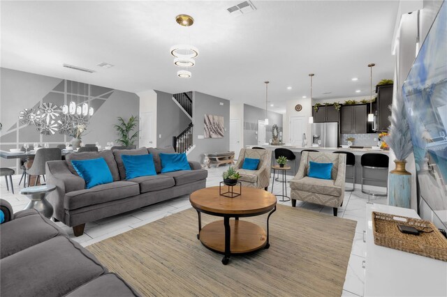 1560 Maidstone Ct, Davenport, FL 33896 - living area featuring a chandelier, stairway, and recessed lighting