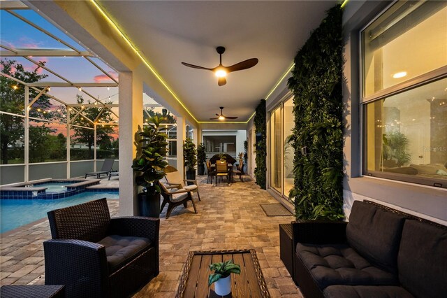 1560 Maidstone Ct, Davenport, FL 33896 - patio terrace at dusk with a patio area, a pool with connected hot tub, and a lanai