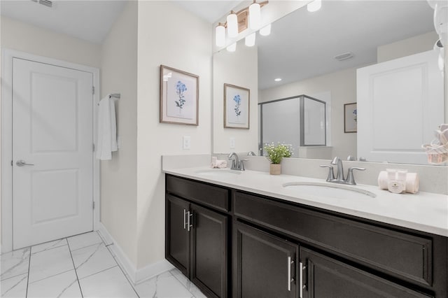 1560 Maidstone Ct, Davenport, FL 33896 - full bathroom with double vanity, marble finish flooring, a shower stall, and baseboards