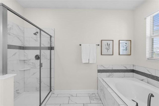 1560 Maidstone Ct, Davenport, FL 33896 - bathroom featuring a garden tub, healthy amount of natural light, marble finish flooring, and baseboards