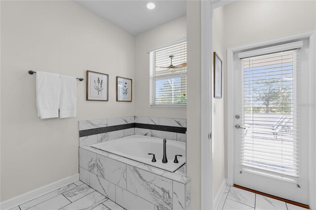 1560 Maidstone Ct, Davenport, FL 33896 - full bathroom with marble finish flooring, baseboards, and a bath