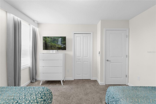 1560 Maidstone Ct, Davenport, FL 33896 - carpeted bedroom with baseboards and a closet