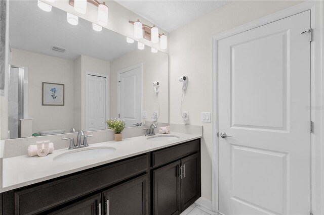 1560 Maidstone Ct, Davenport, FL 33896 - bathroom featuring double vanity and toilet