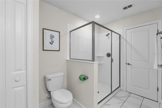 1560 Maidstone Ct, Davenport, FL 33896 - bathroom with marble finish floors, a stall shower, toilet, and baseboards