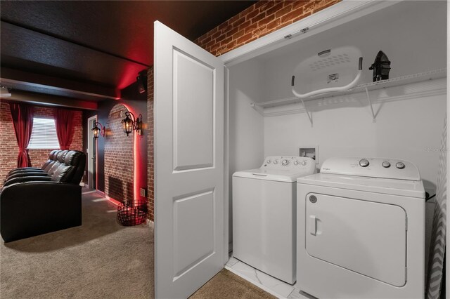 1560 Maidstone Ct, Davenport, FL 33896 - laundry area featuring brick wall, washing machine and clothes dryer, and light colored carpet