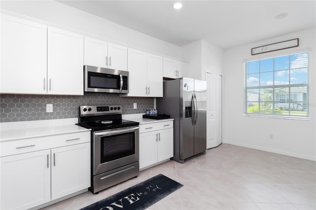 11330 Burgundy Dr, Venice, FL 34293 - kitchen with stainless steel appliances, decorative backsplash, light countertops, white cabinetry, and recessed lighting