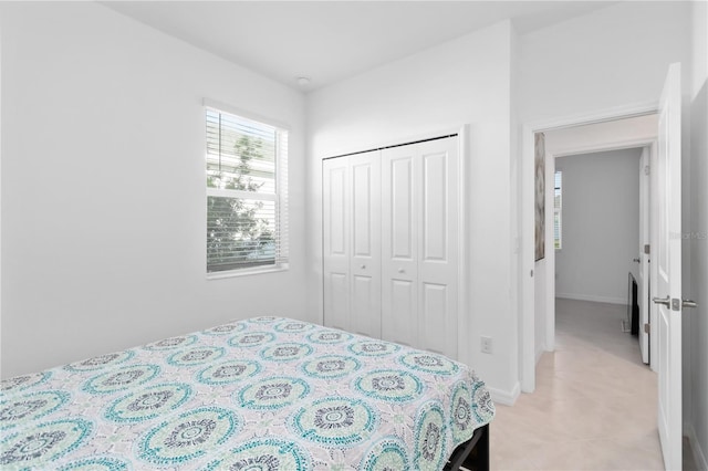 11330 Burgundy Dr, Venice, FL 34293 - bedroom with light tile patterned flooring and a closet