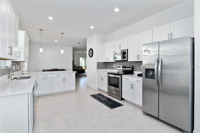 11330 Burgundy Dr, Venice, FL 34293 - kitchen featuring stainless steel appliances, a sink, decorative backsplash, white cabinetry, and recessed lighting