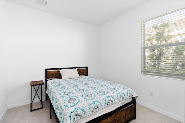 11330 Burgundy Dr, Venice, FL 34293 - bedroom with baseboards and light tile patterned floors