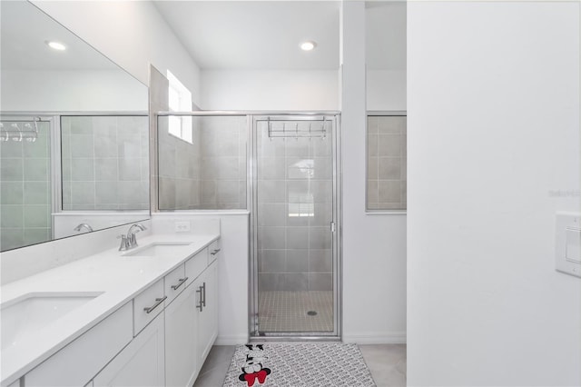 11330 Burgundy Dr, Venice, FL 34293 - full bathroom with double vanity, a stall shower, baseboards, recessed lighting, and tile patterned flooring