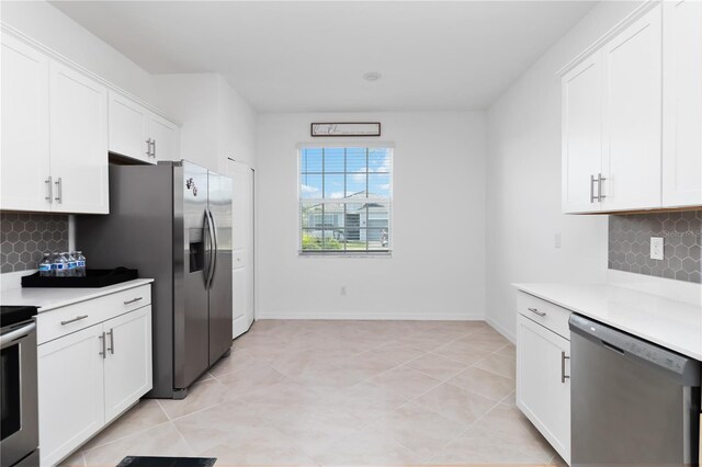 11330 Burgundy Dr, Venice, FL 34293 - kitchen featuring stainless steel appliances, light countertops, backsplash, and white cabinetry