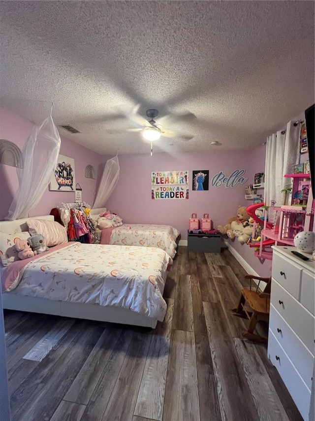 4447 Maple Chase Trl, Kissimmee, FL 34758 - bedroom featuring wood finished floors, a textured ceiling, and a ceiling fan