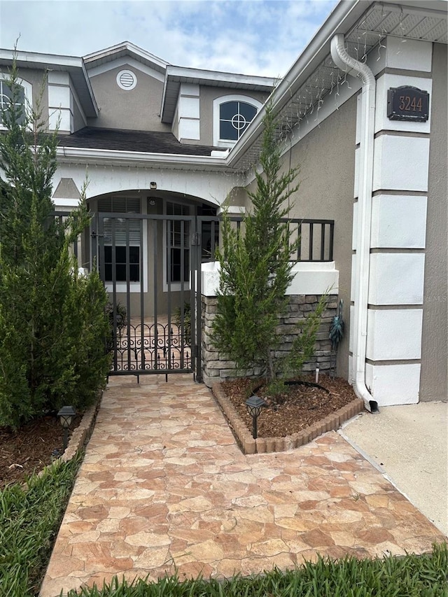 3244 River Branch Cir, Kissimmee, FL 34741 - entrance to property with a gate and stucco siding