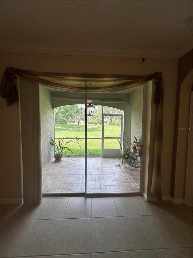 3244 River Branch Cir, Kissimmee, FL 34741 - doorway with ornamental molding, tile patterned flooring, and baseboards