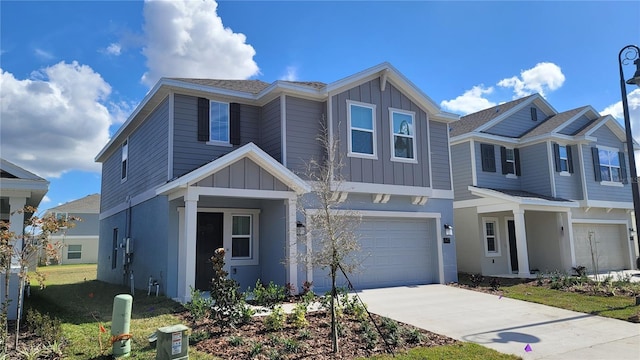 443 Cool Summer Ln, Davenport, FL 33837 - view of front facade featuring board and batten siding, an attached garage, concrete driveway, and stucco siding