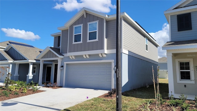 443 Cool Summer Ln, Davenport, FL 33837 - view of front of property with an attached garage, driveway, and board and batten siding