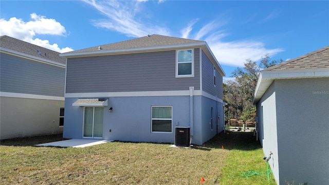 443 Cool Summer Ln, Davenport, FL 33837 - back of house with a yard, central AC, and stucco siding
