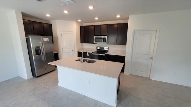 443 Cool Summer Ln, Davenport, FL 33837 - kitchen featuring appliances with stainless steel finishes, a sink, dark brown cabinetry, light countertops, and recessed lighting