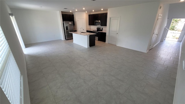 443 Cool Summer Ln, Davenport, FL 33837 - kitchen featuring stainless steel appliances, open floor plan, a center island with sink, recessed lighting, and light countertops