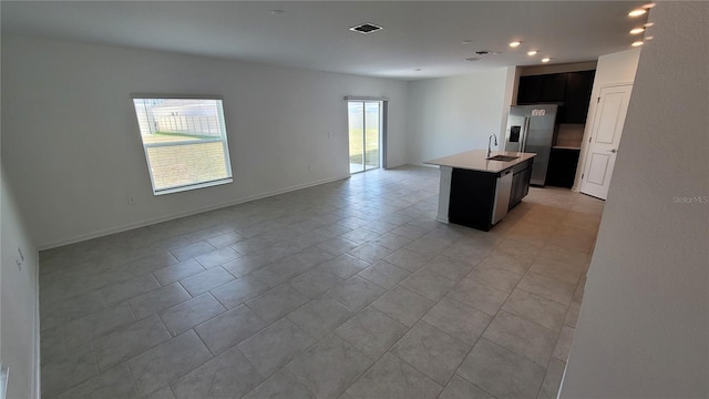 443 Cool Summer Ln, Davenport, FL 33837 - kitchen featuring open floor plan, a sink, stainless steel refrigerator with ice dispenser, recessed lighting, and an island with sink