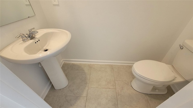 443 Cool Summer Ln, Davenport, FL 33837 - half bathroom featuring toilet, baseboards, and tile patterned flooring