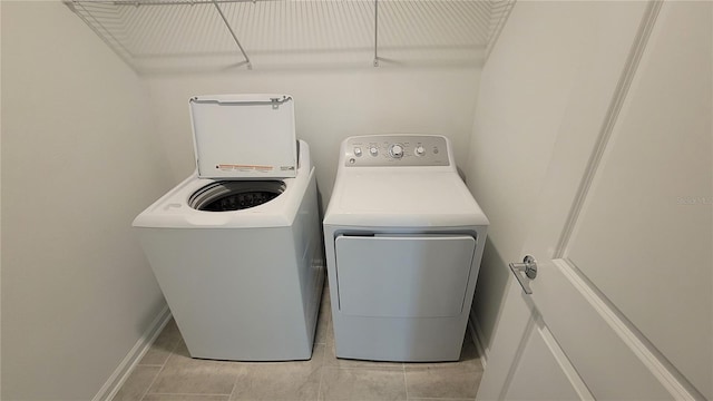 443 Cool Summer Ln, Davenport, FL 33837 - laundry room with separate washer and dryer and light tile patterned floors