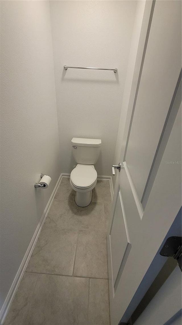 443 Cool Summer Ln, Davenport, FL 33837 - bathroom with tile patterned flooring, baseboards, and toilet