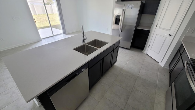 443 Cool Summer Ln, Davenport, FL 33837 - kitchen with stainless steel appliances, a sink, dark cabinets, light countertops, and light tile patterned floors
