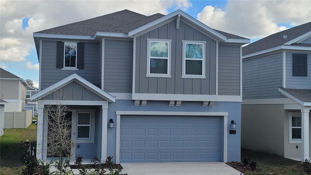 443 Cool Summer Ln, Davenport, FL 33837 - view of front of house with board and batten siding, concrete driveway, a garage, and a shingled roof