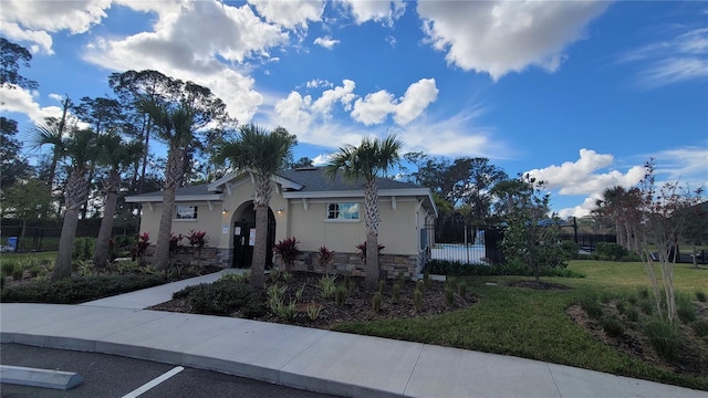 443 Cool Summer Ln, Davenport, FL 33837 - view of front of property featuring stone siding, stucco siding, and uncovered parking