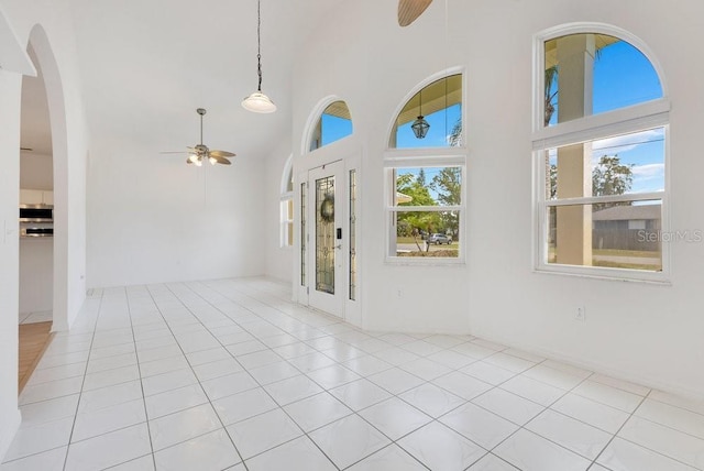 6555 Bay Tree Ct, Saint Cloud, FL 34771 - foyer with ceiling fan, a towering ceiling, tile patterned floors, and arched walkways