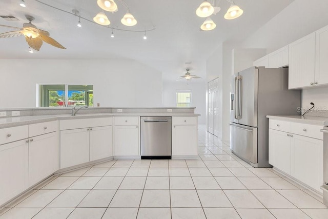 6555 Bay Tree Ct, Saint Cloud, FL 34771 - kitchen with stainless steel appliances, ceiling fan, light countertops, and white cabinetry