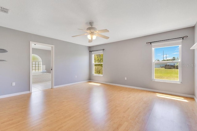 6555 Bay Tree Ct, Saint Cloud, FL 34771 - unfurnished room featuring ceiling fan, light wood finished floors, and baseboards
