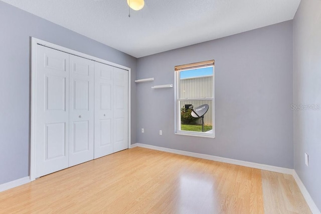 6555 Bay Tree Ct, Saint Cloud, FL 34771 - unfurnished bedroom with wood finished floors, a closet, and baseboards