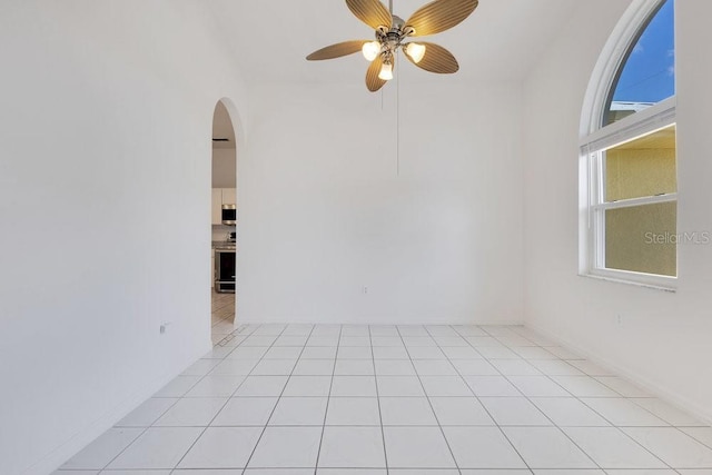 6555 Bay Tree Ct, Saint Cloud, FL 34771 - spare room featuring arched walkways and a ceiling fan