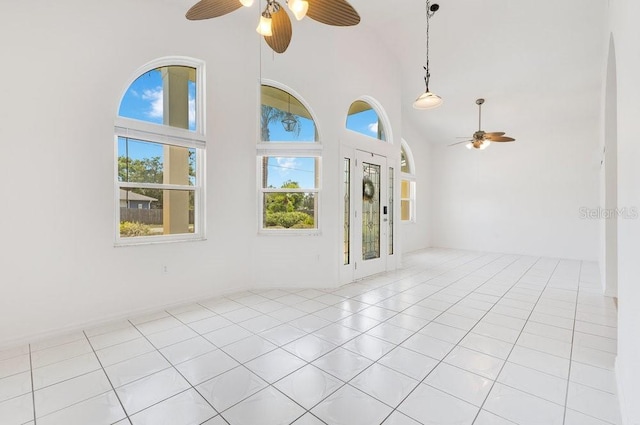 6555 Bay Tree Ct, Saint Cloud, FL 34771 - spare room featuring a ceiling fan, a towering ceiling, and light tile patterned floors