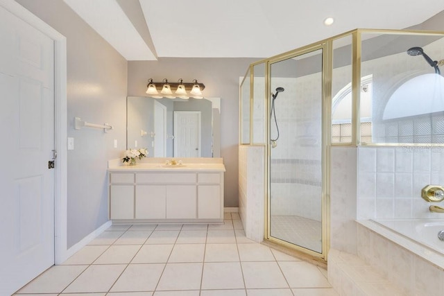 6555 Bay Tree Ct, Saint Cloud, FL 34771 - bathroom featuring vanity, a stall shower, a garden tub, tile patterned floors, and baseboards
