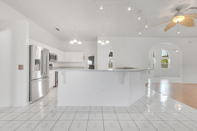 6555 Bay Tree Ct, Saint Cloud, FL 34771 - kitchen featuring appliances with stainless steel finishes, light countertops, light tile patterned floors, and white cabinetry