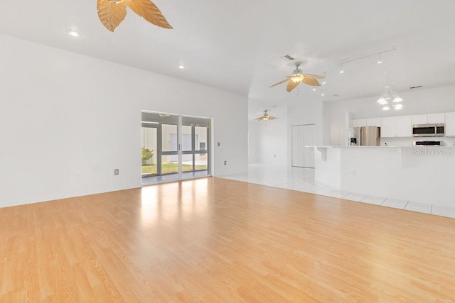 6555 Bay Tree Ct, Saint Cloud, FL 34771 - unfurnished living room featuring ceiling fan, light wood-style flooring, a chandelier, and recessed lighting