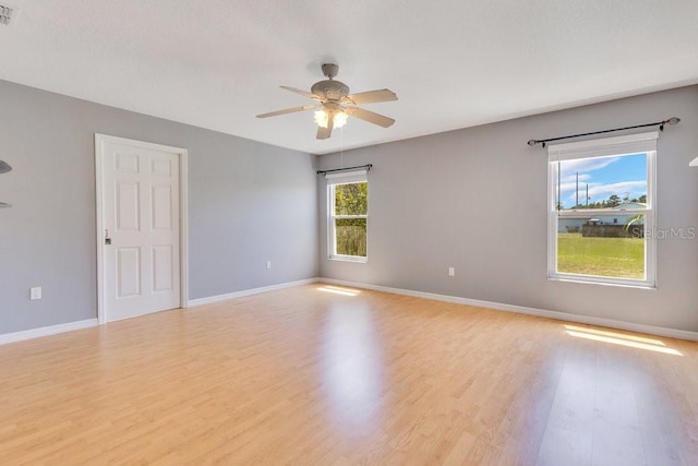 6555 Bay Tree Ct, Saint Cloud, FL 34771 - unfurnished room featuring light wood-style floors, a ceiling fan, and baseboards