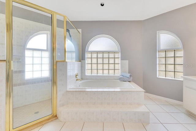 6555 Bay Tree Ct, Saint Cloud, FL 34771 - full bathroom featuring a garden tub, a shower stall, and tile patterned flooring