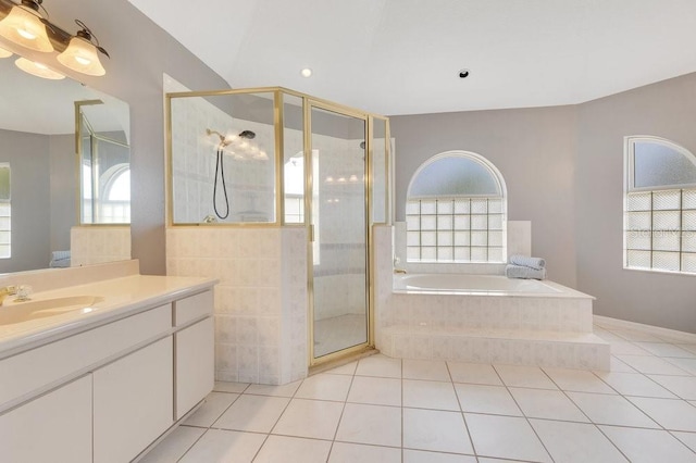 6555 Bay Tree Ct, Saint Cloud, FL 34771 - full bathroom featuring healthy amount of natural light, vanity, a garden tub, and tile patterned flooring