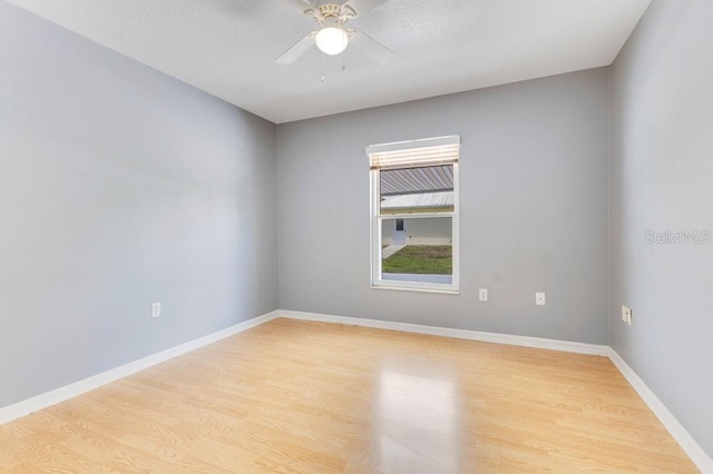 6555 Bay Tree Ct, Saint Cloud, FL 34771 - empty room with light wood-style floors, a ceiling fan, and baseboards
