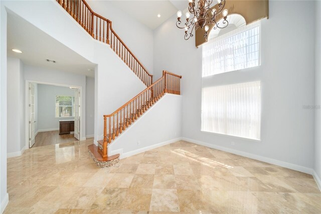 2333 Pinehurst Ct, Davenport, FL 33837 - foyer with a high ceiling, stairway, a chandelier, and baseboards