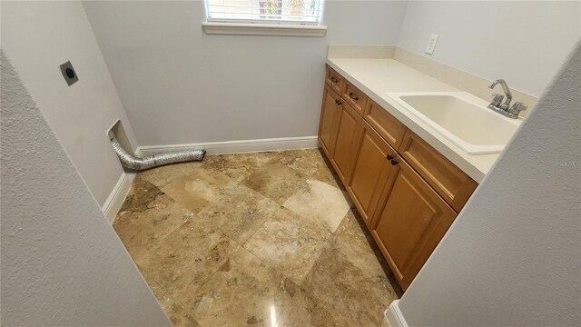 2333 Pinehurst Ct, Davenport, FL 33837 - bathroom with stone finish floors, baseboards, and vanity
