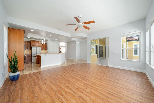 2333 Pinehurst Ct, Davenport, FL 33837 - unfurnished living room featuring ceiling fan, light wood finished floors, baseboards, and recessed lighting