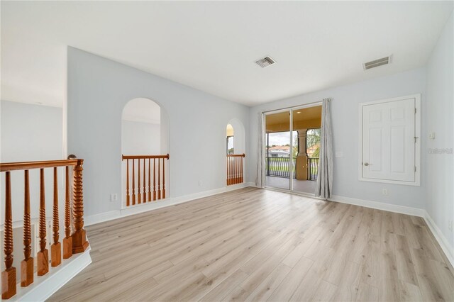 2333 Pinehurst Ct, Davenport, FL 33837 - spare room with light wood-style flooring, baseboards, and arched walkways