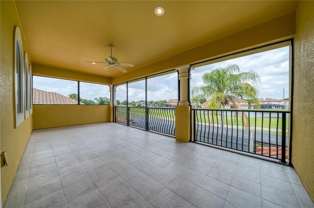 2333 Pinehurst Ct, Davenport, FL 33837 - unfurnished sunroom with tile patterned floors and a textured wall