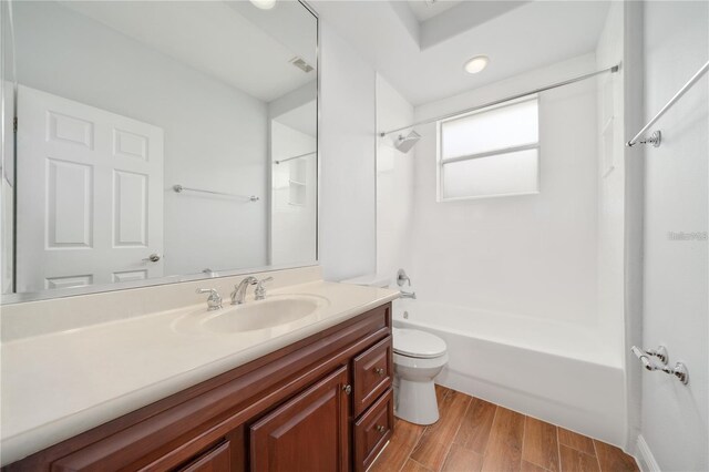 2333 Pinehurst Ct, Davenport, FL 33837 - bathroom with vanity, toilet, bathtub / shower combination, and wood finished floors