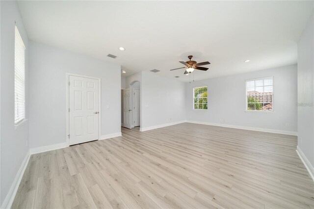 2333 Pinehurst Ct, Davenport, FL 33837 - empty room featuring light wood-style flooring, ceiling fan, recessed lighting, baseboards, and arched walkways